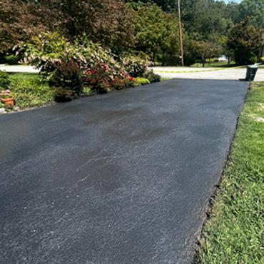 Asphalt sealcoating residential driveway